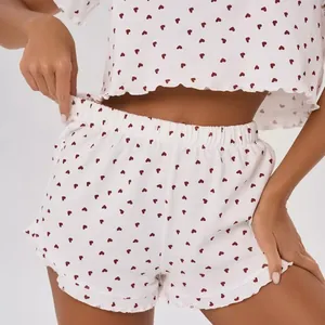 Two-piece women's 100% cotton pajama set with red heart print and elastic waist shorts.