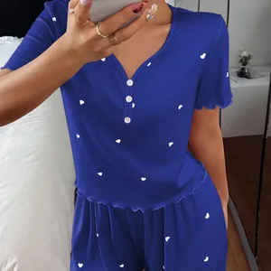 Two-piece blue ribbed short sleeve pajama set featuring white heart print and long pants