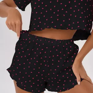 Two-piece black heart print pajama set with short sleeves and elastic waist shorts