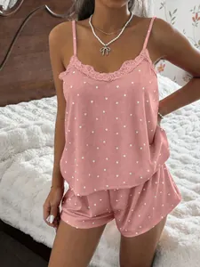 Detailed view of pink heart print ribbed pajama set with lace trim camisole and shorts.