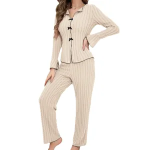Elegant beige ribbed two-piece pajama set for women with delicate black piping accents