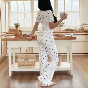 Stylish women's two-piece pajama set featuring colorful heart prints and ribbed fabric