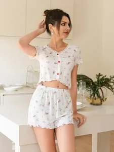 Close-up of floral print button-up short sleeve pajama set with ruffled edges
