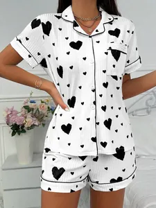 Detail view of white ribbed pajama set with black heart print on model