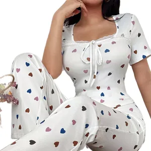 Sweet women's white pajama set with colorful heart print and delicate lace trim