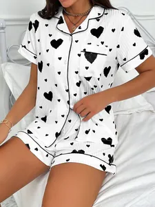 Close-up detail of women's white ribbed pajama set featuring black heart print.
