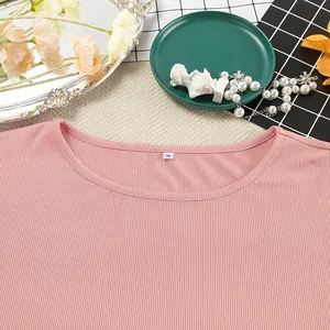 Close-up detail of pink ribbed knit loungewear top showing neckline and soft texture.