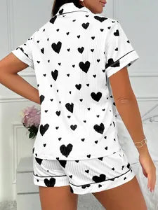 Back view detail of women's short-sleeve pajama set with black heart print pattern