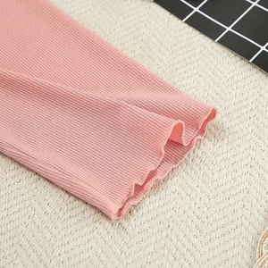 Detailed macro shot of pink ribbed knit fabric with lettuce edge for loungewear set