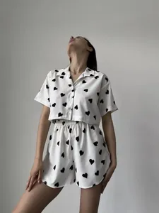 Close-up of women's two-piece loungewear set with black heart pattern