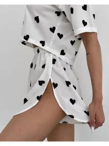 Side view of heart print pajama set featuring cropped top and high slit shorts