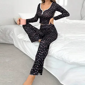 Two-piece floral print pajama set featuring V-neck lace-trim top and matching long pants