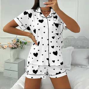 Stylish women's heart print pajama set featuring button-down shirt and matching shorts