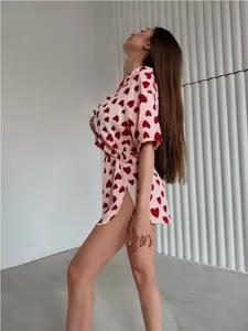 Detailed side view of pink heart print pajama set with side slit shorts for women