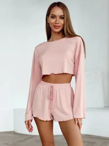 Women's pink ribbed knit crop top and shorts two-piece loungewear set close-up view