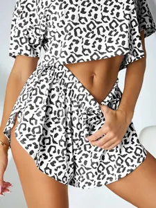 Close-up detail of sexy leopard print pajama set with short sleeves and split shorts.