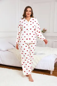 Detail view of plus size women's pajama set with red heart prints on white fabric