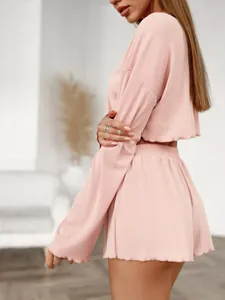 Detailed view of pink ribbed knit long sleeve crop top and shorts loungewear set