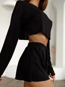 Side view detail of black ribbed knit long sleeve crop top and shorts loungewear set