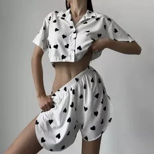 Sexy white two-piece heart print pajama set with cropped button top and slit shorts