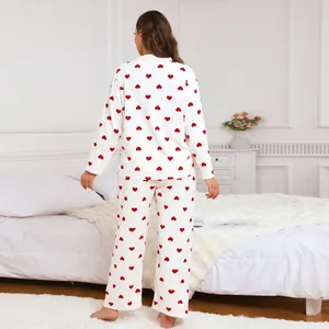 Plus size women's two-piece pajama set in white featuring festive red heart patterns
