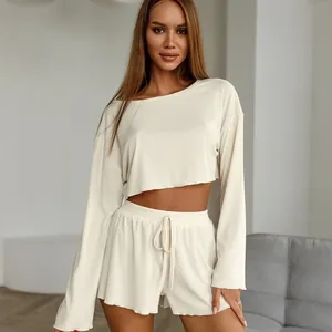Detailed shot showing the soft ribbed texture of cream long sleeve crop top and shorts set