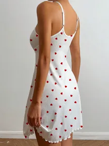Back view of a white ribbed camisole nightgown featuring a cute red heart print pattern.