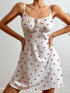 Detail view of white camisole nightdress with red heart print and front tie bow