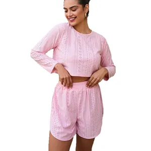 Women's pink eyelet two-piece pajama set with long sleeve crop top and shorts