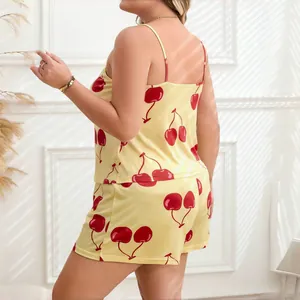 Back view of women's yellow cherry print pajama set featuring camisole and shorts.