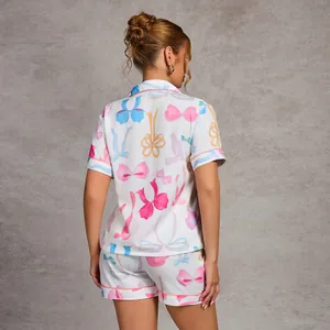 Women's two-piece pajama set with colorful bow print, featuring short sleeves and shorts.
