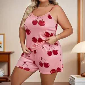 Close-up detail of soft pink camisole and shorts pajama set with red cherry print