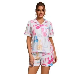 Two-piece pajama set with colorful bow print, short sleeve button-up and shorts