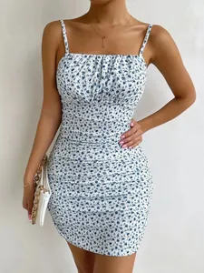 Close-up detail view of white ruched mini dress with delicate blue floral print design