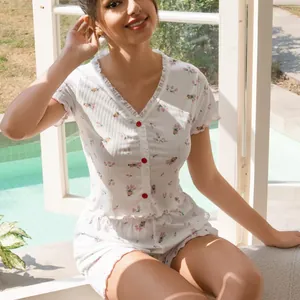 Elegant floral two-piece pajama set featuring a button-front short sleeve top and shorts
