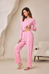 Women's pink ribbed pajama set with lace lapel and bow details in cozy loungewear style