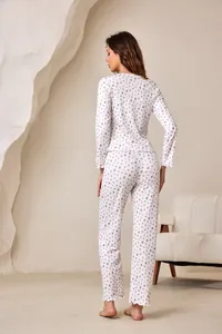 Back view of women's floral pajama set with long sleeves and ruffled lettuce hems