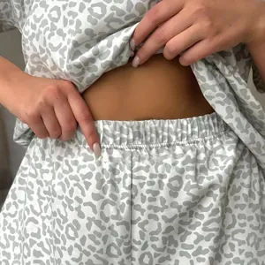 Women's grey and white leopard print pajama set with comfortable elastic waistband.