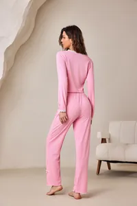 Back view of a pink ribbed loungewear set featuring white lace trim and cute bow details.