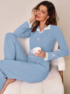 Elegant blue ribbed pajama set with delicate white lace collar and pink bow details