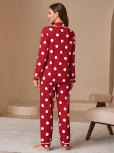Back view of women's red polka dot pajama set with long sleeves and white piping detail.