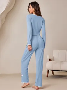 Back view of light blue ribbed pajama set featuring delicate white lace trim details