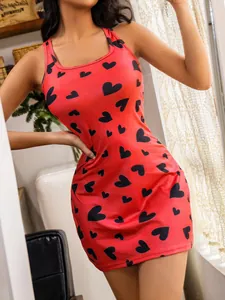 Detailed view of red bodycon dress with black heart pattern and slim straps