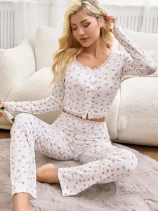 Detailed view of the floral print and lace trim on the long-sleeved pajama set