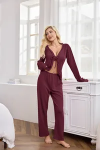 Detail view of burgundy tie-front pajama set worn by model in a bright indoor setting