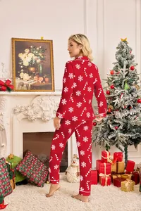 Back view of women's red Christmas pajama set with snowflake print in holiday scene