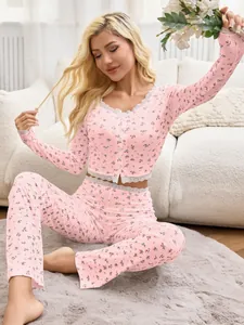 Detailed view of pink floral long sleeve pajama set with delicate lace trim on model