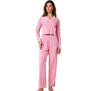Elegant pink two-piece pajama set with delicate lace trim and bow detail for women's loungewear