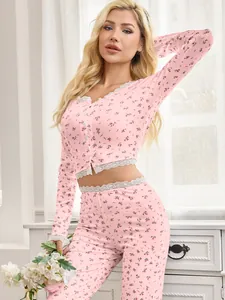 Detailed view of women's pink floral pajama set featuring elegant white lace trim accents