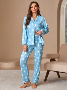 Detailed view of women's blue polka dot pajama set with long sleeves and notched collar.